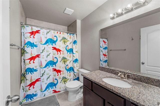 bathroom featuring tile patterned flooring, vanity, toilet, a textured wall, and visible vents