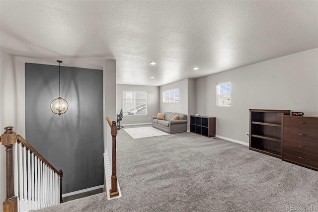 interior space featuring recessed lighting, baseboards, and a textured ceiling