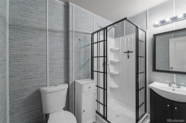 full bath featuring tile walls, a stall shower, toilet, and vanity