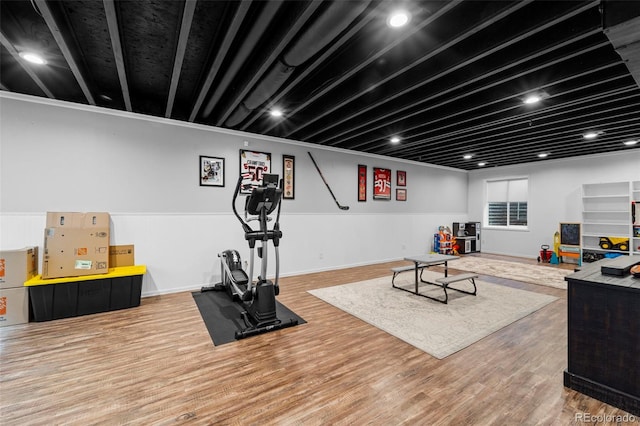 workout area with wood finished floors