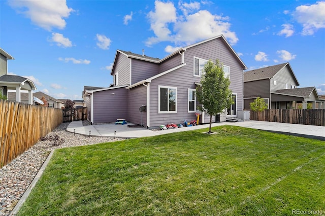 back of property with a fenced backyard, a patio area, and a lawn