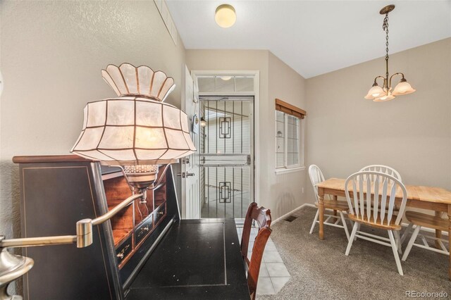 228 Quari St, Aurora, CO 80011 - dining space with a chandelier and carpet floors