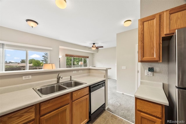 228 Quari St, Aurora, CO 80011 - kitchen with dishwasher, freestanding refrigerator, ceiling fan, light countertops, and brown cabinets