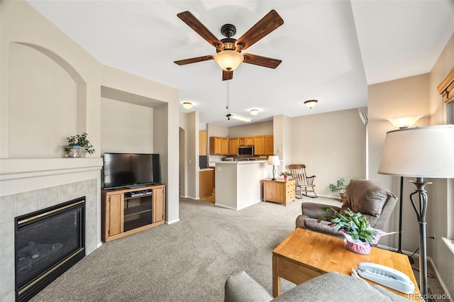 228 Quari St, Aurora, CO 80011 - living area featuring light colored carpet, ceiling fan, and a fireplace