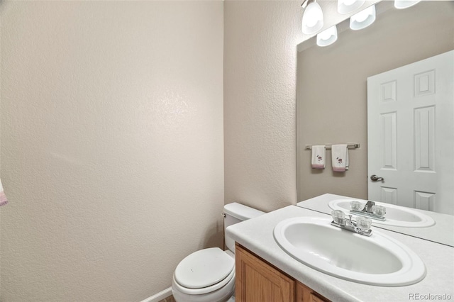 228 Quari St, Aurora, CO 80011 - half bathroom featuring a textured wall and vanity