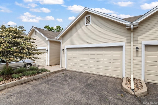 228 Quari St, Aurora, CO 80011 - view of front of property with asphalt driveway and an attached garage