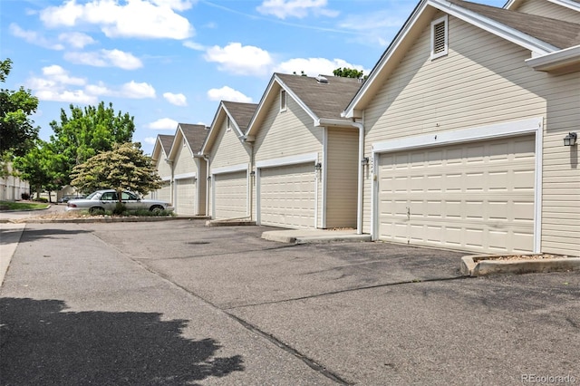 228 Quari St, Aurora, CO 80011 - view of front of house with asphalt driveway and a garage