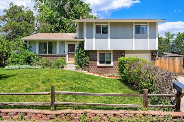 7565 Newland St, Arvada, CO 80003 - tri-level home featuring brick siding and a garage