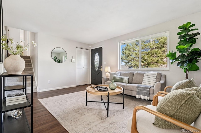 7565 Newland St, Arvada, CO 80003 - living room featuring baseboards and dark wood-style flooring