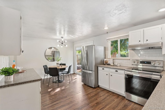 7565 Newland St, Arvada, CO 80003 - kitchen featuring stainless steel appliances, under cabinet range hood, dark wood-type flooring, and white cabinets