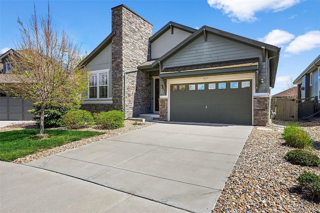 3429 Goodyear St, Castle Rock, CO 80109 - view of front of property featuring stone siding, concrete driveway, a garage, a standing seam roof, and a chimney