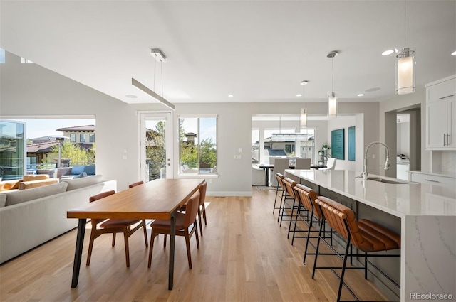 2136 S Juniper St, Lakewood, CO 80228 - dining area with light wood-style floors, recessed lighting, and baseboards