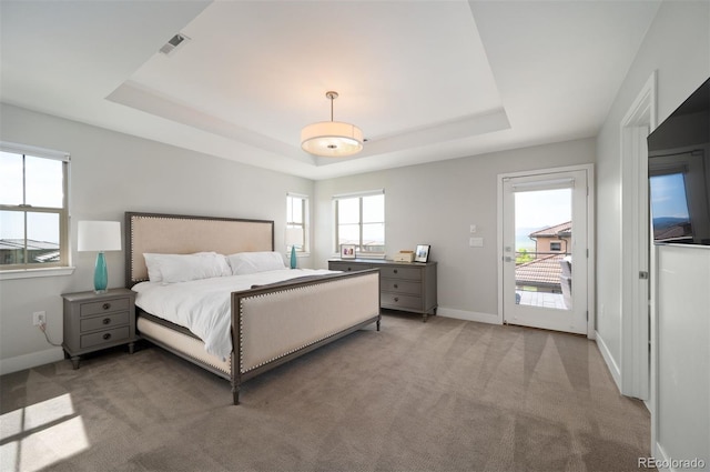 2136 S Juniper St, Lakewood, CO 80228 - bedroom featuring a tray ceiling, light colored carpet, baseboards, and access to outside