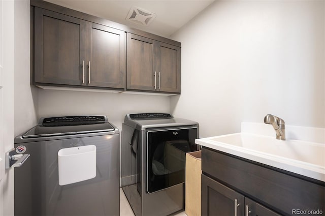 2136 S Juniper St, Lakewood, CO 80228 - laundry area featuring washing machine and clothes dryer and cabinet space