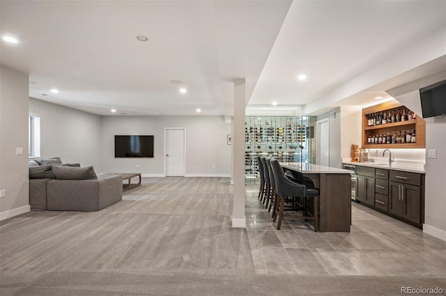 2136 S Juniper St, Lakewood, CO 80228 - dining space featuring bar with sink, recessed lighting, baseboards, and light carpet