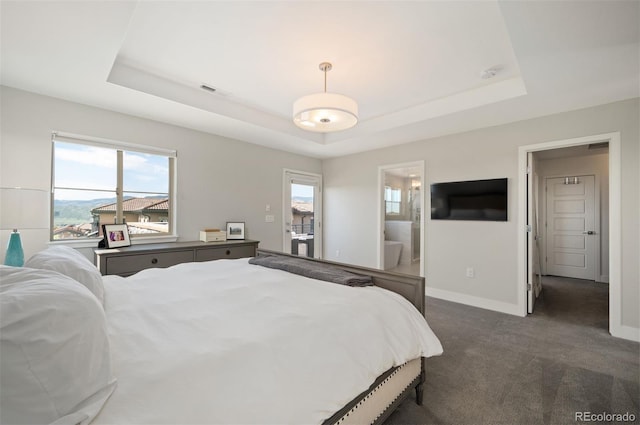 2136 S Juniper St, Lakewood, CO 80228 - bedroom featuring a tray ceiling, dark carpet, baseboards, and ensuite bath