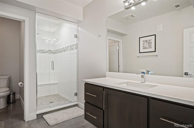 2136 S Juniper St, Lakewood, CO 80228 - full bathroom with toilet, a shower stall, tile patterned flooring, vanity, and baseboards