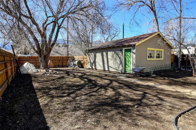 exterior space featuring an outbuilding and a fenced backyard