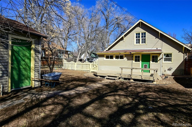 back of house featuring fence