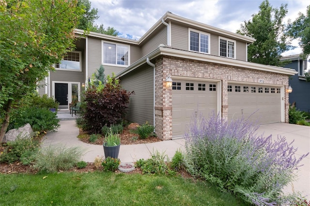 view of front of home with driveway and a garage