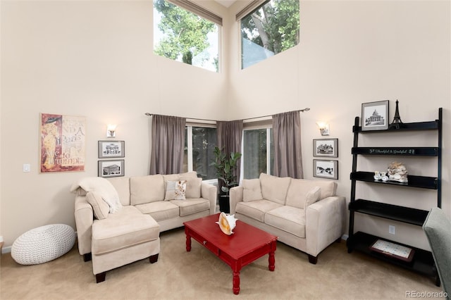 carpeted living room with a high ceiling