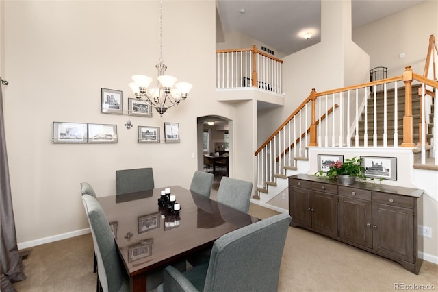 dining space featuring an inviting chandelier, stairs, and light carpet