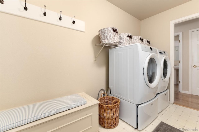 washroom featuring laundry area, light floors, and separate washer and dryer