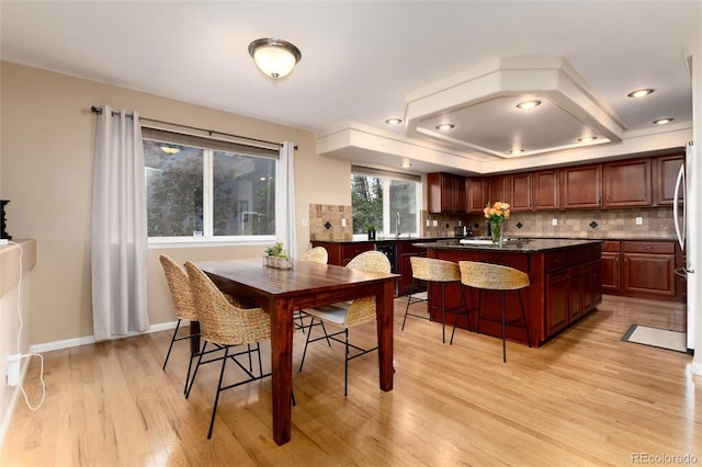 dining space with light wood-style floors and baseboards
