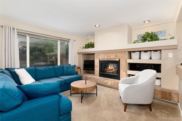 carpeted living room with recessed lighting and a tile fireplace