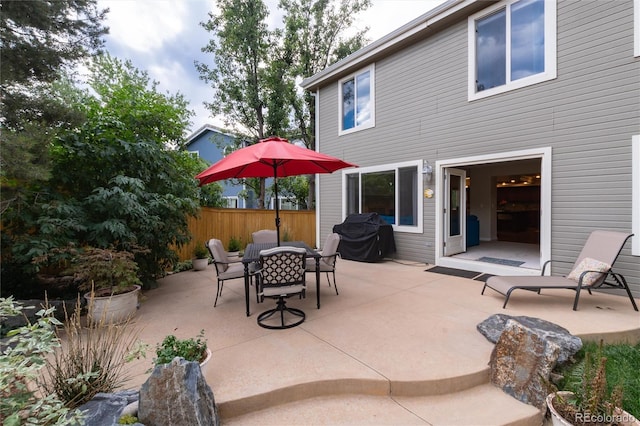 view of patio with fence and outdoor dining area