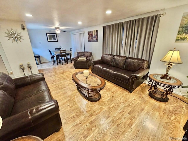 living room featuring ceiling fan and light wood-type flooring