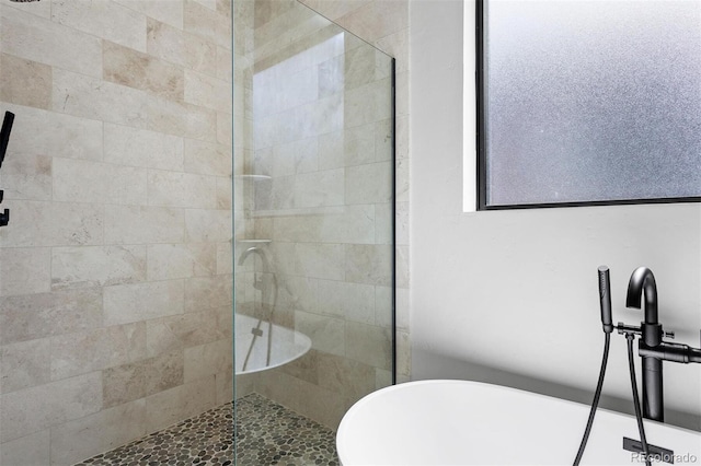 bathroom with shower with separate bathtub