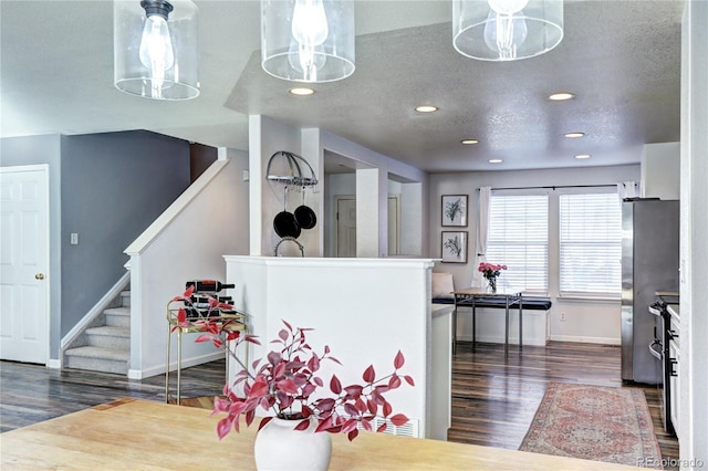 kitchen featuring a textured ceiling, recessed lighting, dark wood-style flooring, baseboards, and freestanding refrigerator