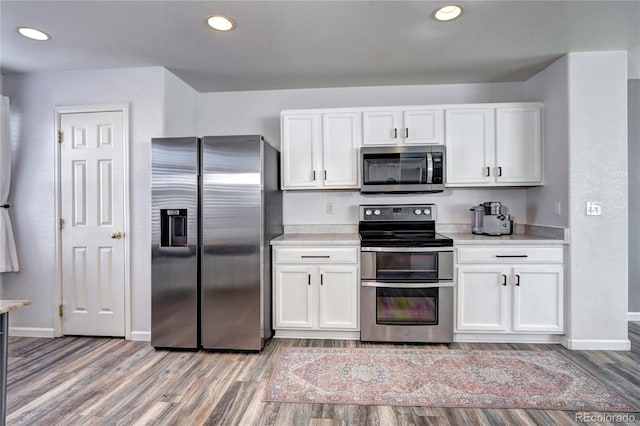 kitchen featuring light countertops, appliances with stainless steel finishes, and white cabinets