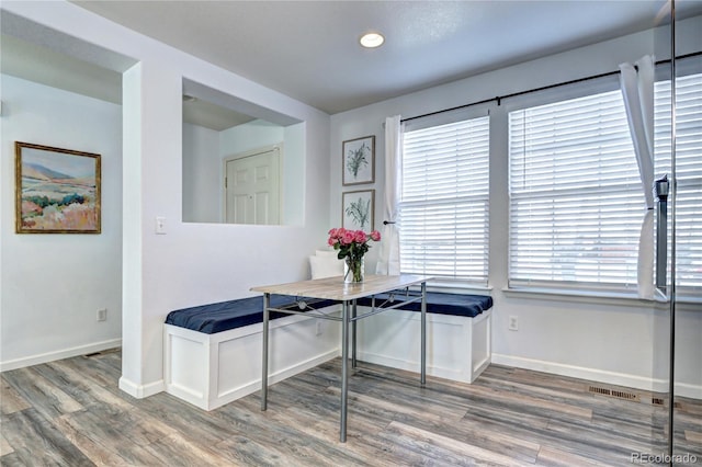 dining room with a healthy amount of sunlight, baseboards, and wood finished floors