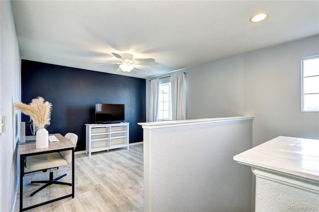 office with light wood finished floors, ceiling fan, and baseboards