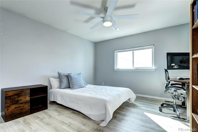 bedroom featuring light wood-style floors, ceiling fan, and baseboards