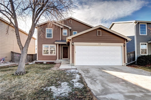 traditional home with a garage, fence, and driveway