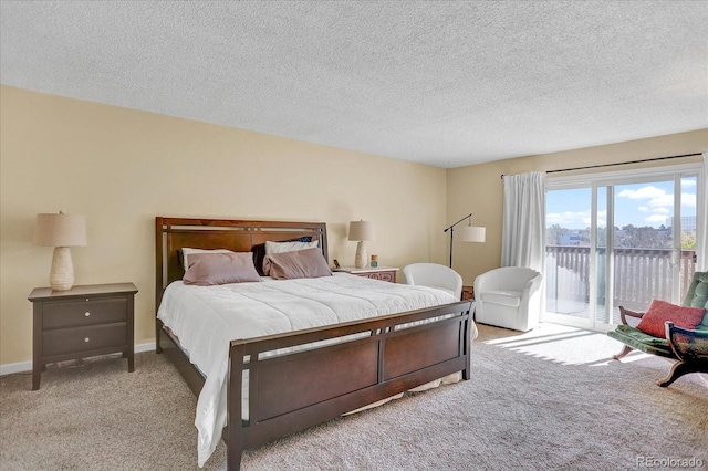 7040 E Girard Ave Unit 406, Denver, CO 80224 - carpeted bedroom featuring access to outside and a textured ceiling