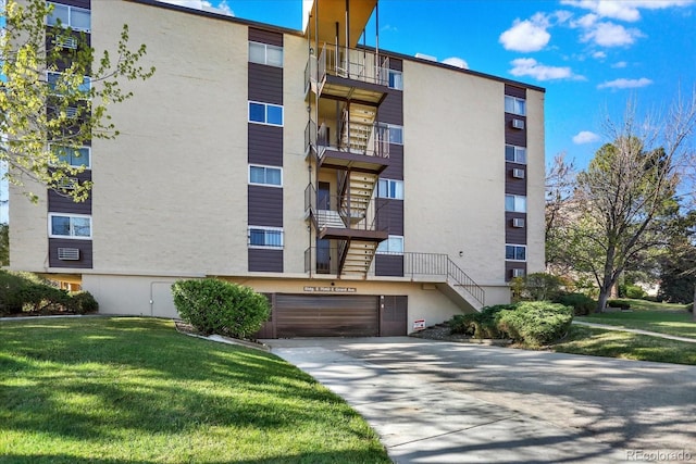 7040 E Girard Ave Unit 406, Denver, CO 80224 - view of apartment building / complex with concrete driveway and an attached garage