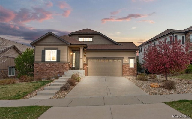 craftsman-style house with stone siding, driveway, and an attached garage