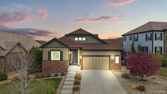 7790 S Queensburg Way, Aurora, CO 80016 - view of front of property featuring stone siding, driveway, a garage, and roof with shingles