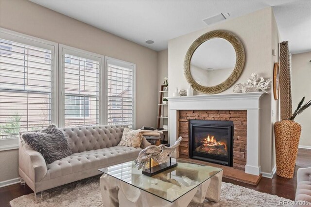 7790 S Queensburg Way, Aurora, CO 80016 - living room featuring wood finished floors and a stone fireplace