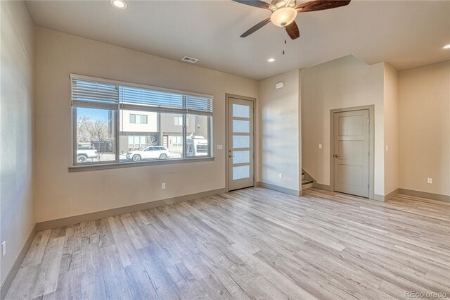 spare room featuring light hardwood / wood-style floors and ceiling fan