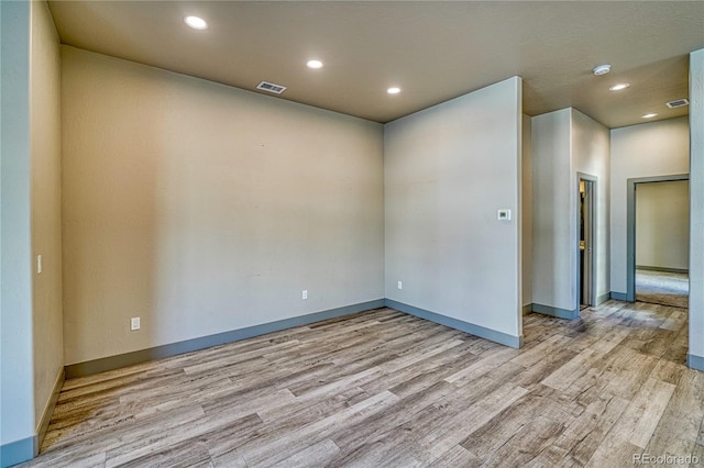 empty room with light hardwood / wood-style floors