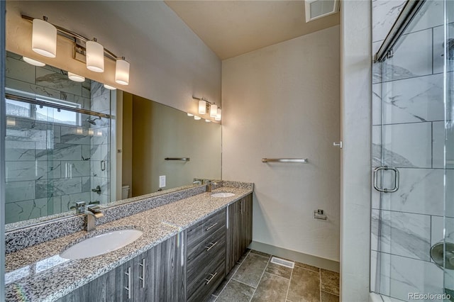 bathroom with vanity, a shower with door, and toilet