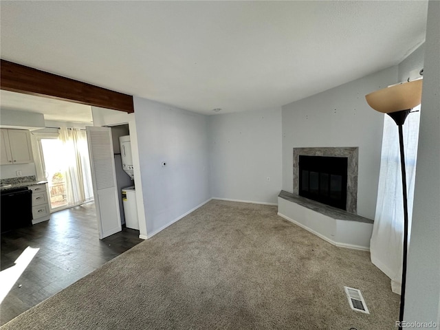 unfurnished living room featuring beamed ceiling and hardwood / wood-style flooring