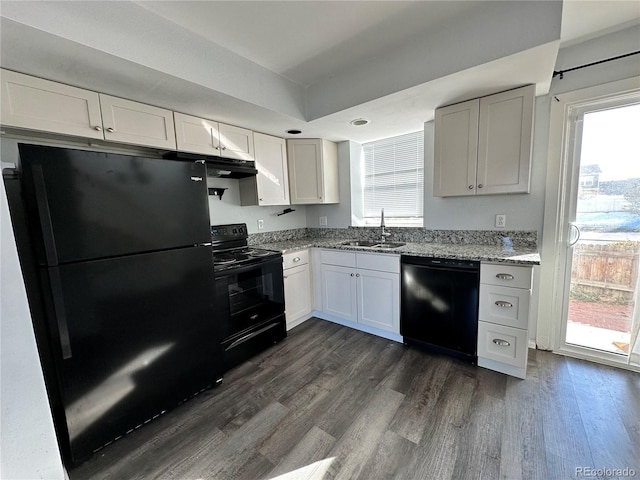 kitchen featuring white cabinets, dark wood-type flooring, a healthy amount of sunlight, and black appliances