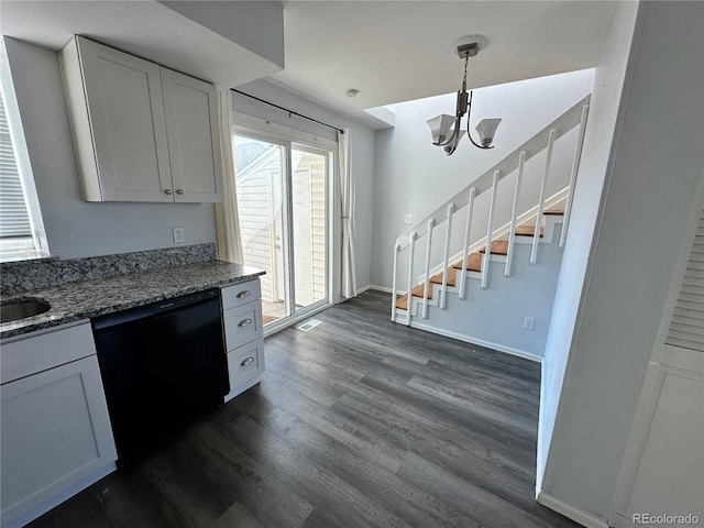 kitchen with white cabinets, dishwasher, dark stone countertops, and dark wood-type flooring