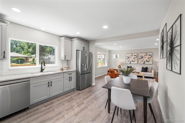 4903 W 11th Ave, Denver, CO 80204 - kitchen with appliances with stainless steel finishes, recessed lighting, healthy amount of natural light, light wood-style floors, and gray cabinetry
